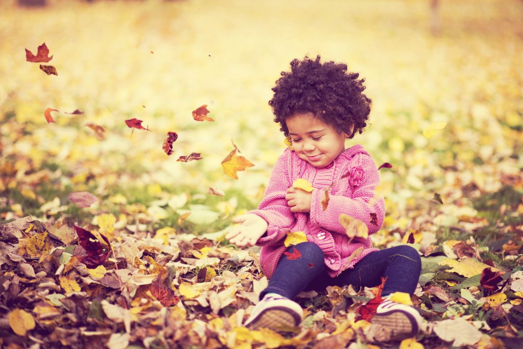 Girl in fall leaves